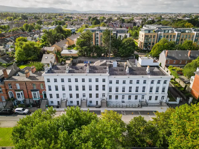 Aerial view of The Linn, a white terrace of period houses on Morehampton Road, with Donnybrook and the Dublin Mountains beyond